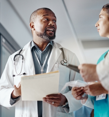 Two Medical professionals discussing office needs for systems and processes